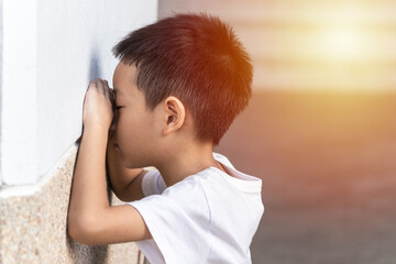 The cute Asian little boy is playing hide and seek with the funny moments. Asian kid crying on the...