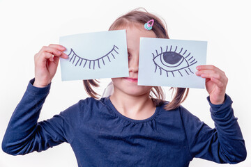 Young girl with painted closed and open eyes as symbol of double standards and cunning.