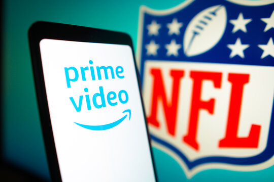 January 23, 2024, Brazil. In this photo illustration, the Amazon Prime Video logo is displayed on a smartphone screen and National Football League (NFL) logo in the background.