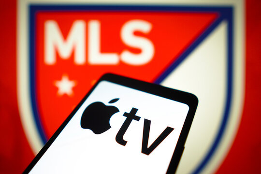 January 23, 2024, Brazil. In this photo illustration, the Apple TV logo is displayed on a smartphone screen and Major League Soccer (MLS) logo in the background.