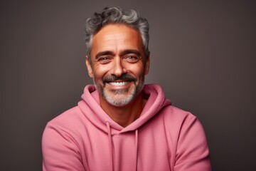 Obraz premium Portrait of a joyful man in his 50s wearing a thermal fleece pullover against a solid color backdrop. AI Generation