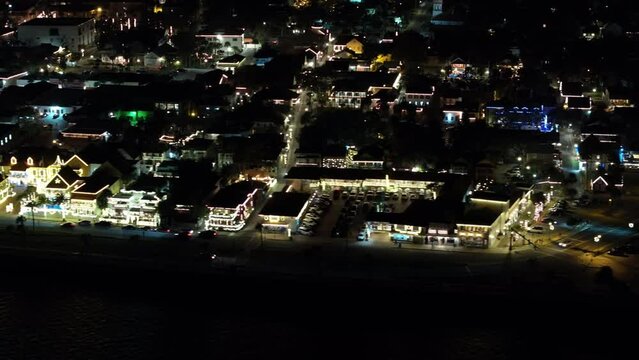 Night aerial stock footage St Augustine Florida holiday lights and fort