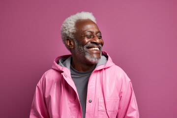 Obraz premium Portrait of a grinning afro-american man in his 60s wearing a windproof softshell against a solid pastel color wall. AI Generation