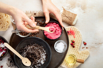 A woman's hand applies a natural coffee scrub. Skin care cosmetics. Beauty concept