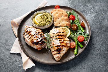 Tasty roast chicken breast, green asparagus and lemon.