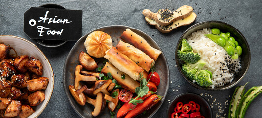 Homemade sesame Chicken served with white rice and vegetables. Asian food dishes.