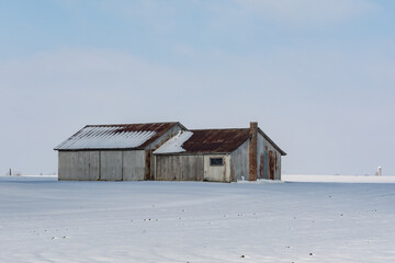 Rural illinois farmland and farm buildings in the snow.  Illinois, USA.