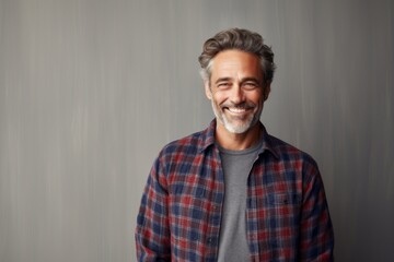 Portrait of a satisfied man in his 50s dressed in a relaxed flannel shirt against a light wood minimalistic setup. AI Generation