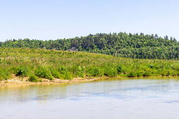a small karst lake located on alpine meadows in early summer.