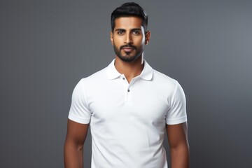 Portrait of a content indian man in his 20s wearing a sporty polo shirt against a plain white digital canvas. AI Generation