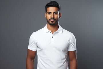 Fototapeta premium Portrait of a content indian man in his 20s wearing a sporty polo shirt against a plain white digital canvas. AI Generation