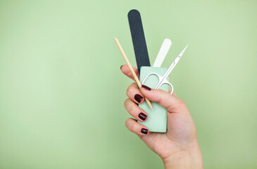 Crop woman with manicure supplies