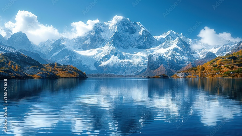 Poster a mountain range with a body of water in the foreground and trees in the foreground, and clouds in t
