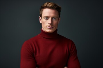 Fototapeta premium Portrait of a tender man in his 20s wearing a classic turtleneck sweater against a plain cyclorama studio wall. AI Generation