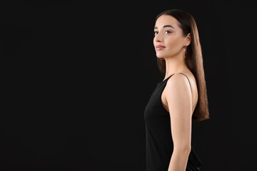 Fototapeta premium Beautiful young woman on black background, space for text