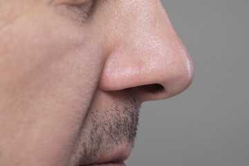 Closeup view of man with normal skin on grey background