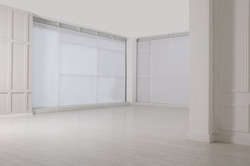 Fototapeta na wymiar Empty room with beige walls and laminated flooring