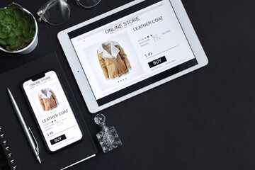 Online shopping. Flat lay composition with modern tablet and smartphone on black background