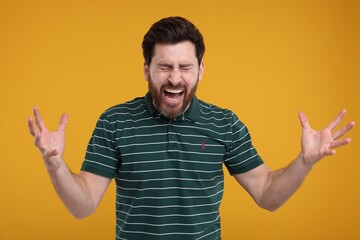 Portrait of surprised man on yellow background