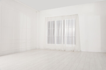 Empty room with white walls and large window