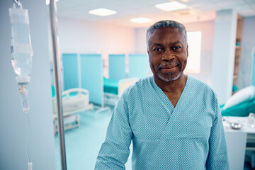 Smiling black senior man during his recovery in hospital looking at camera.