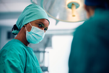 Black female surgeon in operating room at medical clinic.