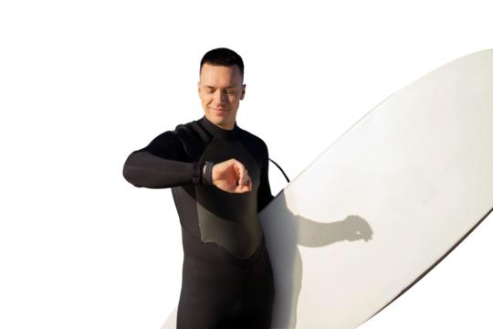 A male surfer in a wetsuit looks at his fitness watch and checks his workout. Isolated transparent background.