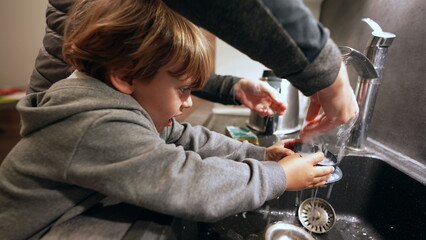 Little Helper, Boy Assisting Mother with Dishes in Kitchen