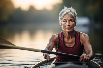 Portrait of a determined mature woman rowing in a lake. With generative AI technology