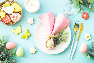 Easter food background. White plate with eggs, spring flowers and easter cookies. Flat lay.