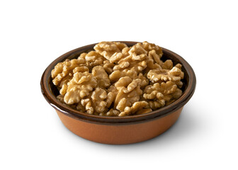 Walnuts in a baked clay dish isolated on empty background