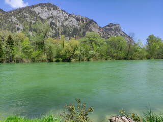 Ebensee, Traun river. Traunsee lake. Green mountain, sunny summer day, blue sky and clouds. Spring Alps, green trees. Town in the mountains. River water. Mountain landscape. Mountain 