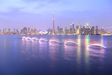 long exposure of a kayaker in front of the night skyline of Toronto