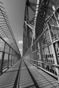 black and white photography of the pedestrian walkway of Jacques Cartier bridge in Montreal