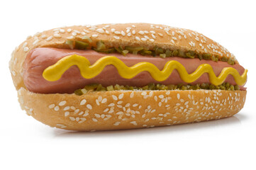closeup of hot dog with mustard and pickle in perspective white background