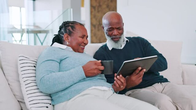 Tablet, search and senior couple on a sofa with coffee, conversation and streaming subscription choice at home. Digital, app and old African people in a living room with online, decision or service
