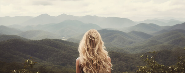 Woman with long wavy blond hairs with nature in background.  Dense long blonde hair rear view - obrazy, fototapety, plakaty