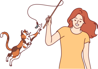 Woman plays with cat and waves bow on string, feeling pleasure thanks to presence of pet. Playful cat jumps up and stretches out paw wanting to catch kitten toy bought at pet store