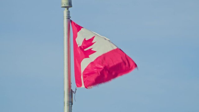 Canada country flag in wind blue sky