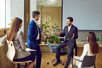 Group of business people engages in a team meeting or training session within the office. Showing a dynamic work environment, where individuals come together to communication.