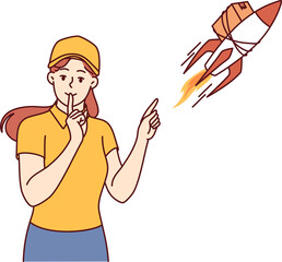 Woman courier near rocket with package puts finger to mouth offering express delivery services