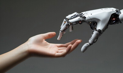 A human hand is reaching for a robotic AI futuristic technology hand. Artificial intelligence concept. Technology meets nature. Machine learning