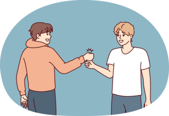 Two young guys bump their fists when they meet, making greeting to members of student fraternity. Positive teenage boys in casual clothes say goodbye after fun together walk