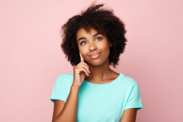 Fototapeta na wymiar Photo of admiring young pretty African American girl brown hair wear cyan crop top touch finger chin dreams look novelty isolated on pink color background