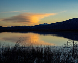 sunset clouds reflecting on a lake