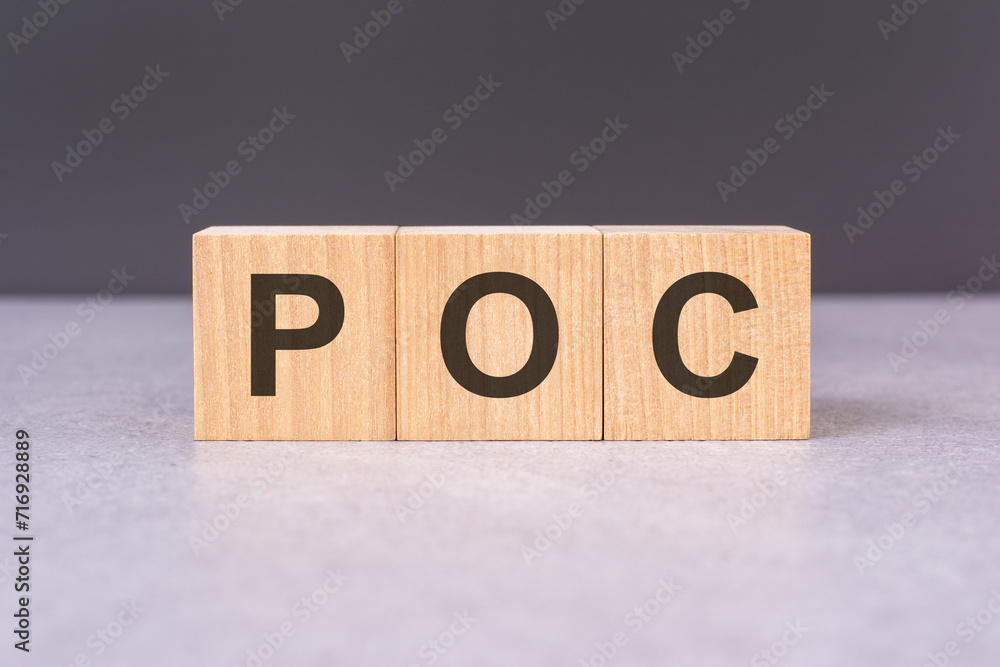 Poster poc - text from wooden blocks with letters, front view on black background