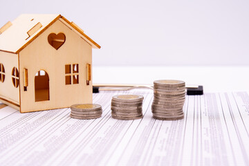 Small houses, coins and office supplies on financial statements