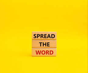 Spread the Word symbol. Concept words Spread the Word on wooden blocks. Beautiful yellow background. Business and Spread the Word concept. Copy space.