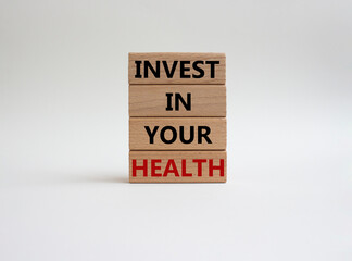 Invest in your Health symbol. Concept words Invest in your Health on wooden blocks. Beautiful white background. Business and Invest in your Health concept. Copy space.