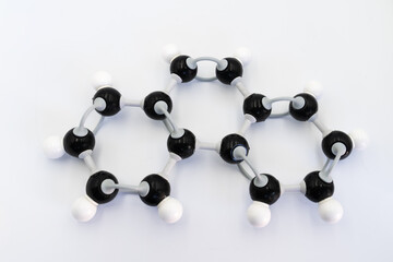 Phenanthrene molecule made by molecular model on white background. Chemical formula with colored...